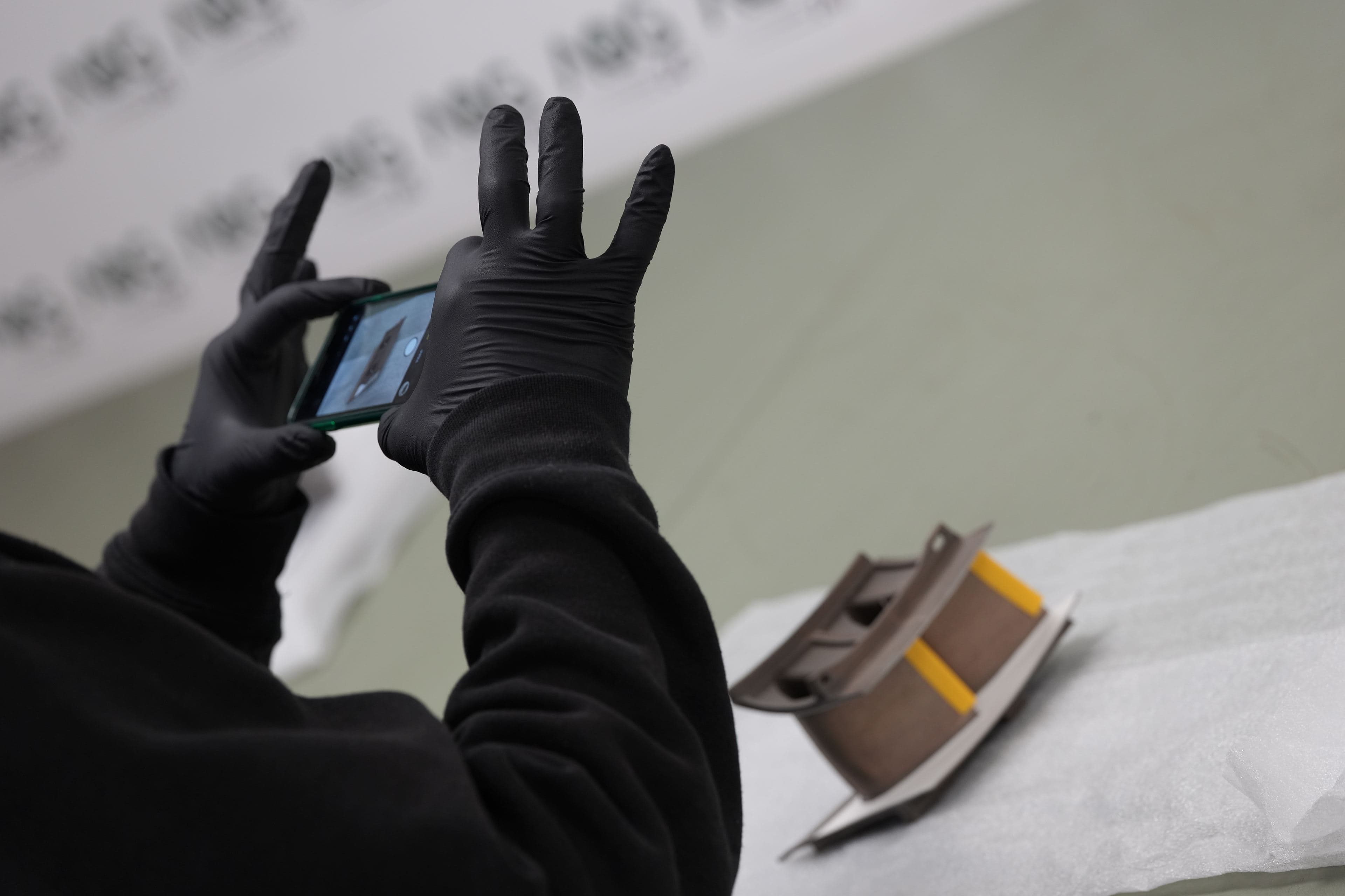 A technician photographing a component for documentation